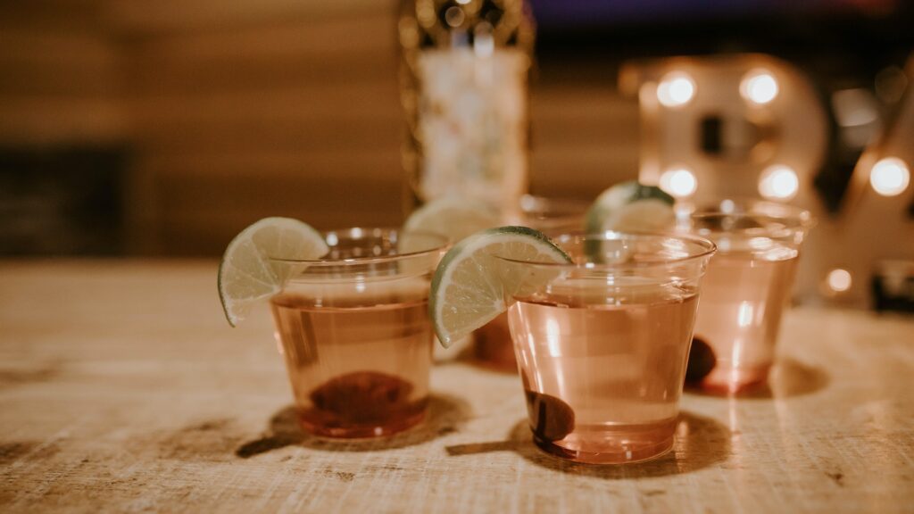 A glass of gin with lime