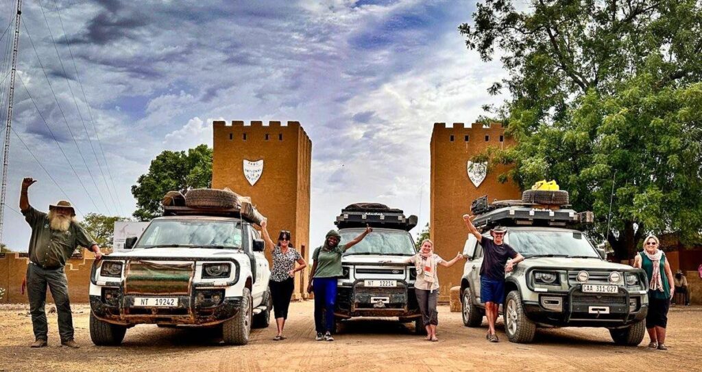 Kingsley Holgate Foundation team standing next to vehicles