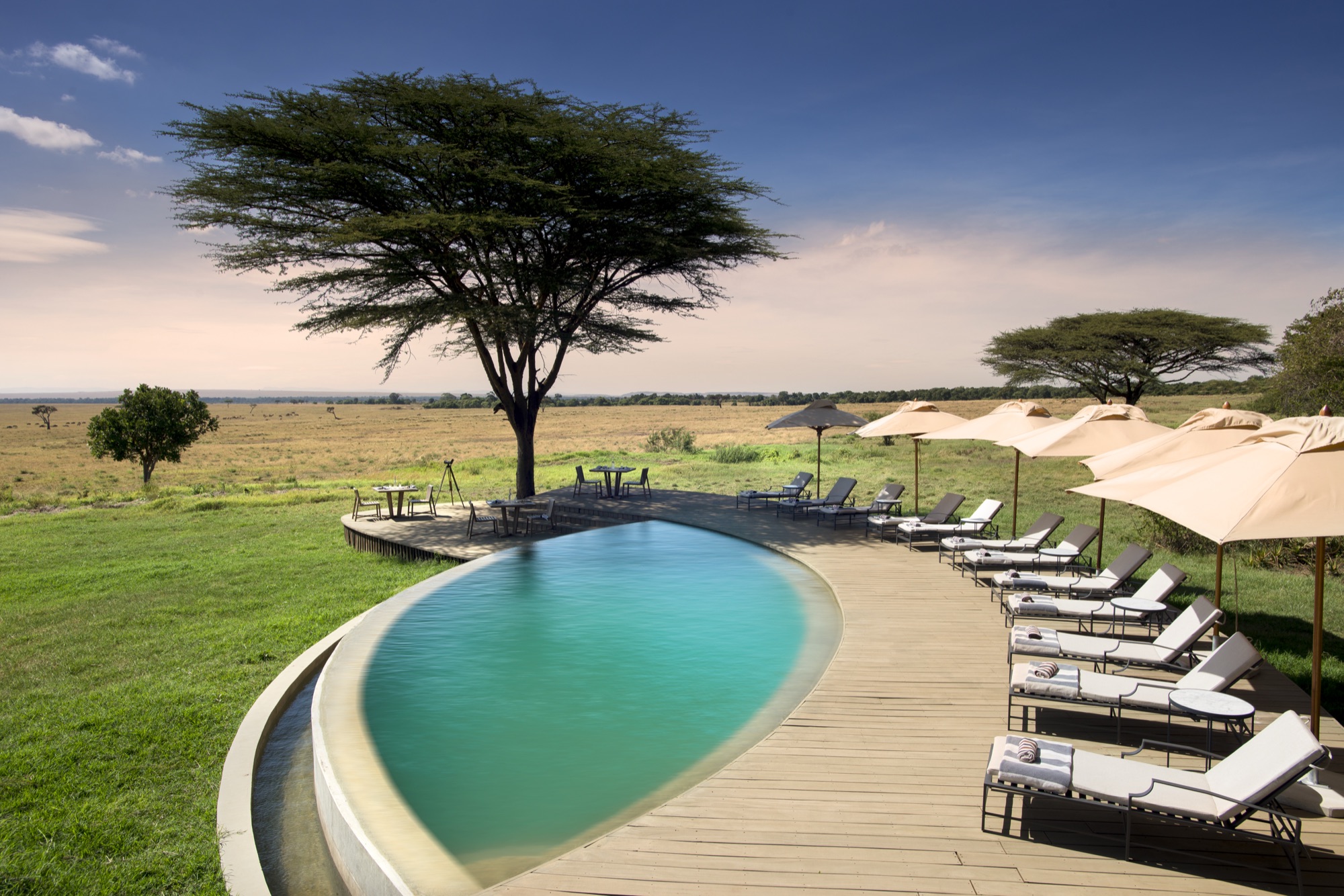 Swimming pool at &Beyond Bateleur Camp with the Masai Mara plains beyond